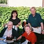 Here's an alt tag for the image: Family celebrating birthday outdoors.