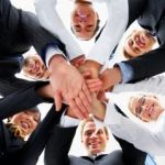 Here's an alt tag for the image: Teamwork: Hands together in a circle.